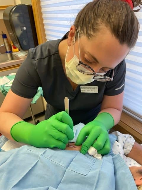Dermatology provider performing a surgical skin procedure at Associated Dermatology & Skin Cancer Clinic in Helena, Montana.